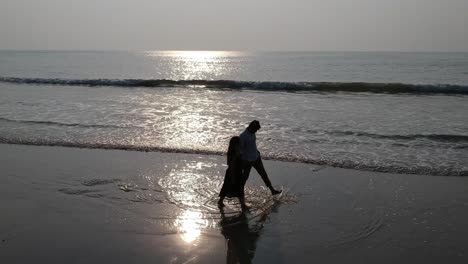 Couple-walking-at-beach---Aerial-drone-video