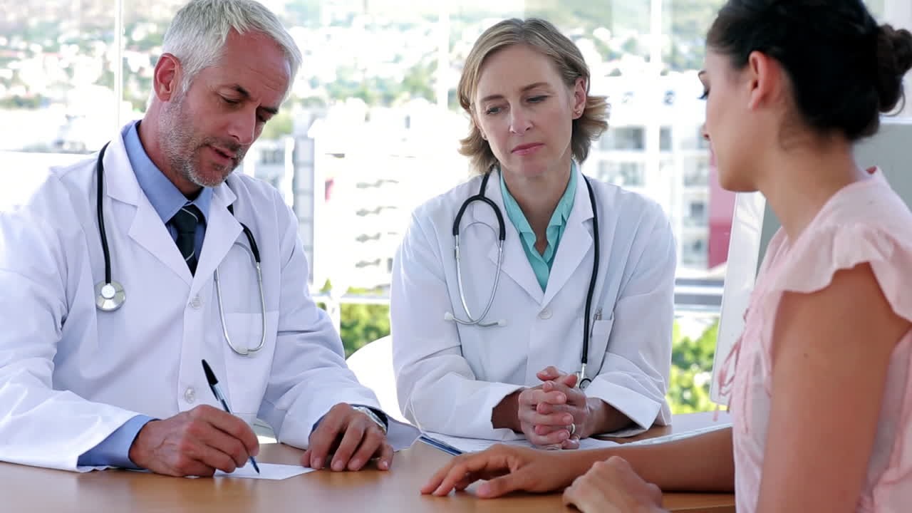 Doctors explaining something to patient