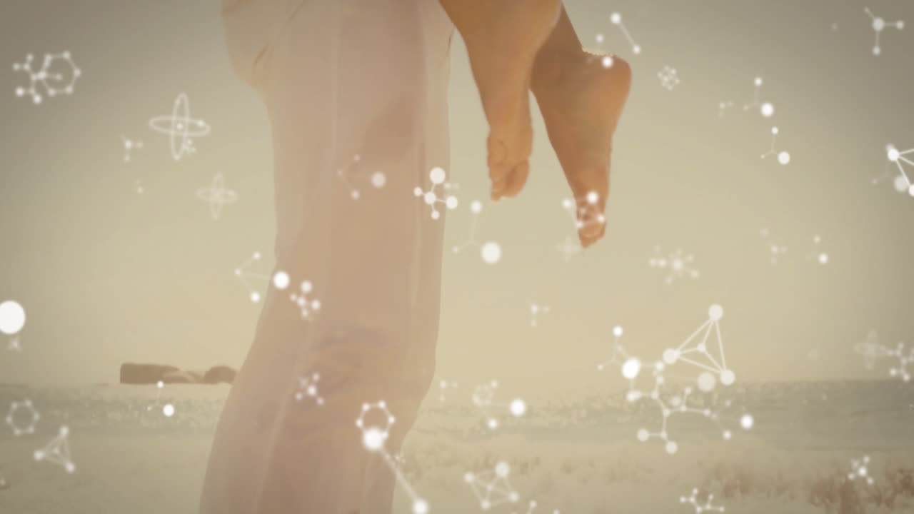 Person carrying someone on beach with molecular structure animation overlay