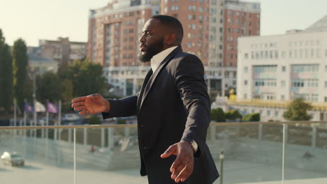 Businessman-dancing-after-work-outdoors.Business-man-celebrating-success-outside