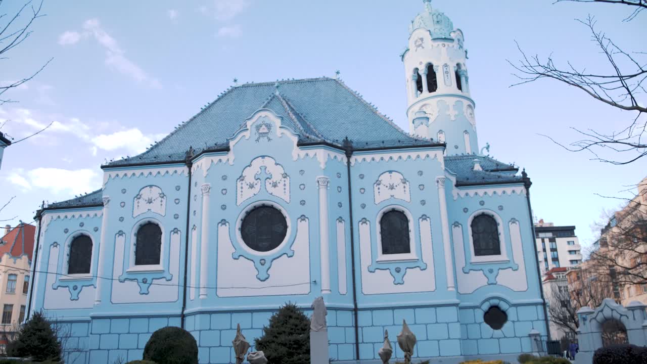 Blue Church garden in Bratislava, Slovakia, shot through railing bars.