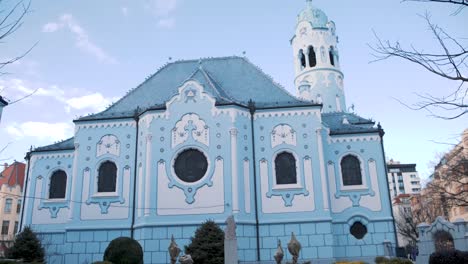 blue church garden in bratislava, slovakia, shot through railing bars.