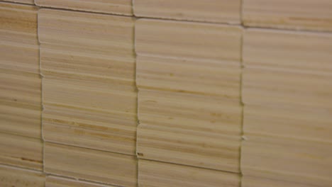 close-up of stacked wooden bed slats in a factory, detail on texture and natural patterns