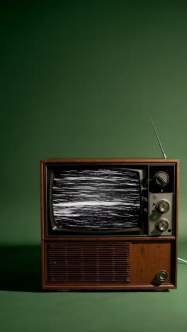 vintage television with static on green background