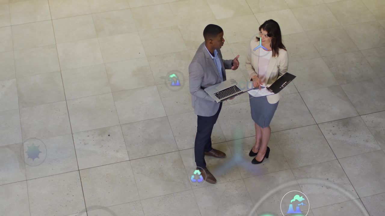 Discussing data with digital analytics overlay, business professionals in office setting