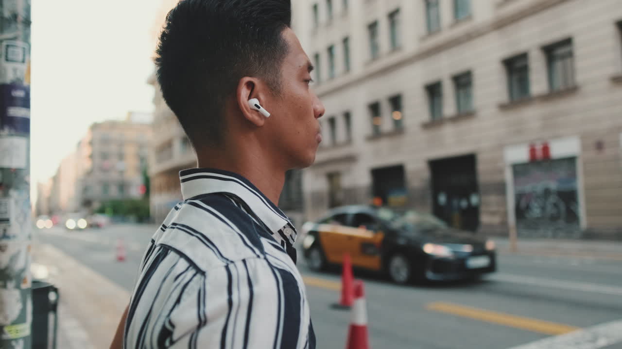 Man with Earbuds on City Street