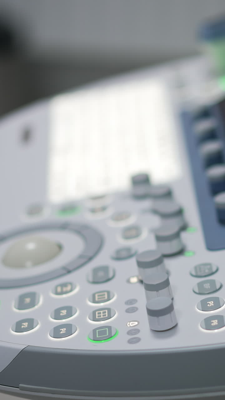 Keyboard, sensor screen and set of buttons on the modern machine for ultrasound diagnostics. Advanced equipment for sonography in clinics. Close up. Blurred backdrop.