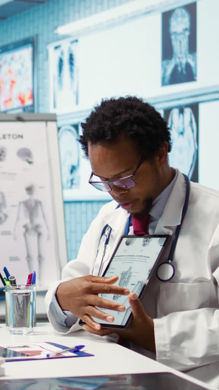 African american specialist showing the human skeleton to explain diagnosis