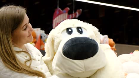 woman hugging a large stuffed dog