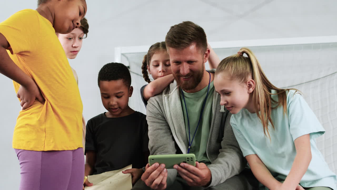 Man and children at the soccer field