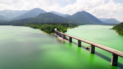 sylvenstein lake and bridge in bavaria, germany - aerial shot