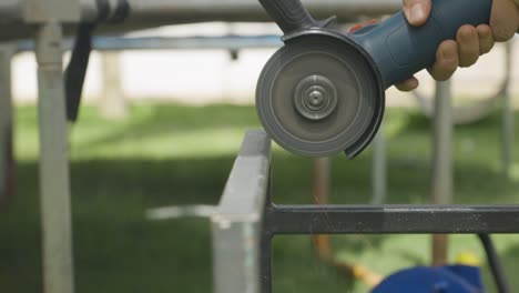 slow-motion-slow-motion-man-grinding-piece-of-square-tubing-engineering