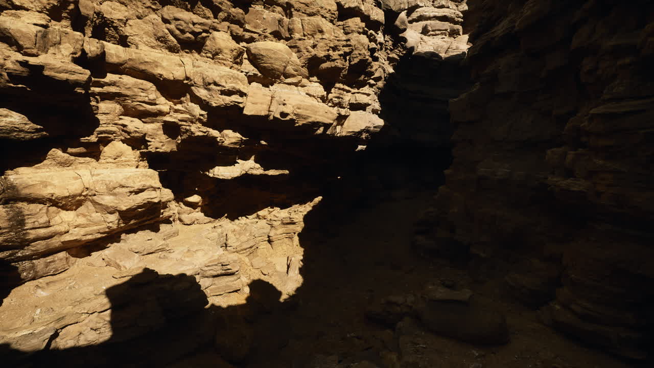 Exploring the narrow canyon with sunlight illuminating rocky walls