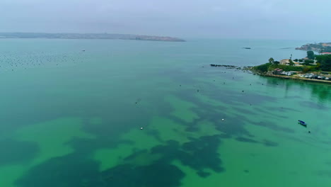 tranquilas aguas turquesas y vistas panorámicas de la isla costera - toma aérea