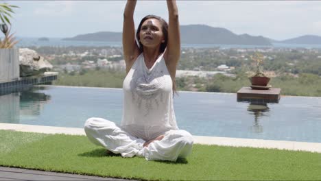 Calm-lady-sitting-in-lotus-position-at-resort