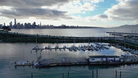 a smooth horizontal side-tracking drone shot of treasure isle marina on yerba buena island, ca. it highlights the marina, boats, and scenic shoreline, perfect for travel, marine, or coastal footage.