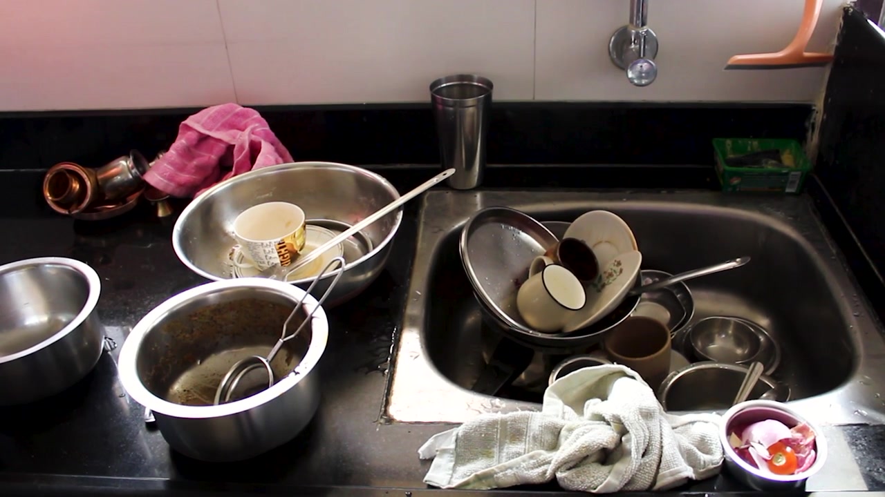 Realistic home kitchen with dirty dishes, pots and utensils left after meal preparation. Ideal for cleaning routines, household chores, hygiene, domestic workload and busy family life concepts.