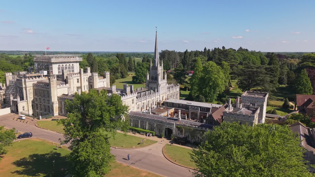 Panoramic view revealing Ashridge House in the English countryside, surrounded by lush green trees and scenic landscapes