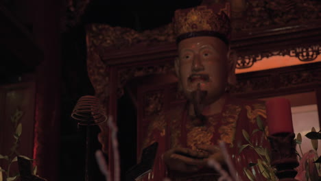 burning incense and statue in the temple of confucius hanoi vietnam