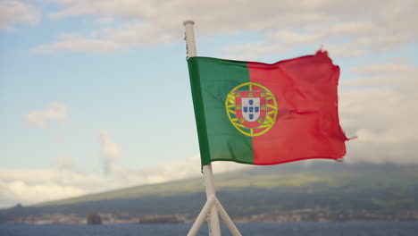 slow motion of portuguese flag waving in back of the boat