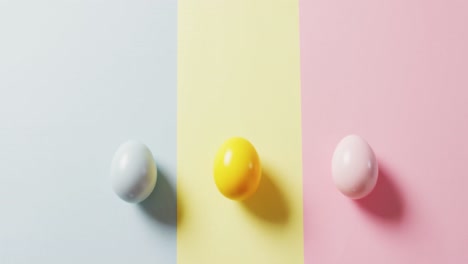 Close-up-of-three-colorful-easter-eggs-on-colorful-background