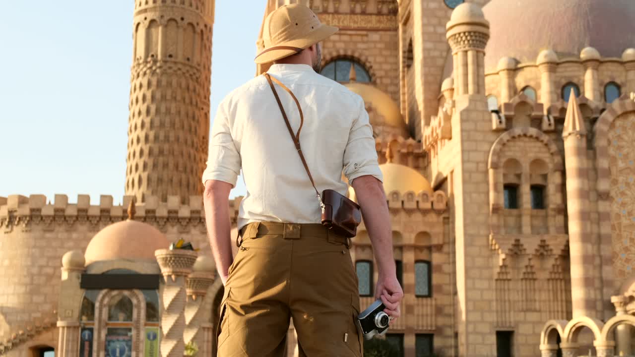 un hombre con un sombrero de viaje y una camisa de lino en el fondo de la mezquita
