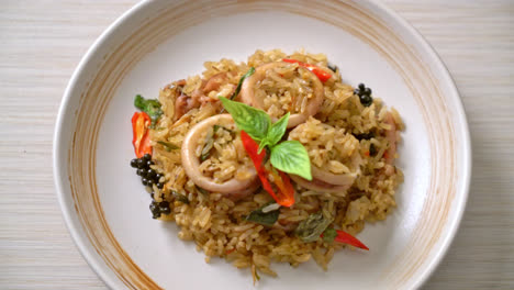 homemade basil and spicy herb fried rice with squid or octopus - asian food style