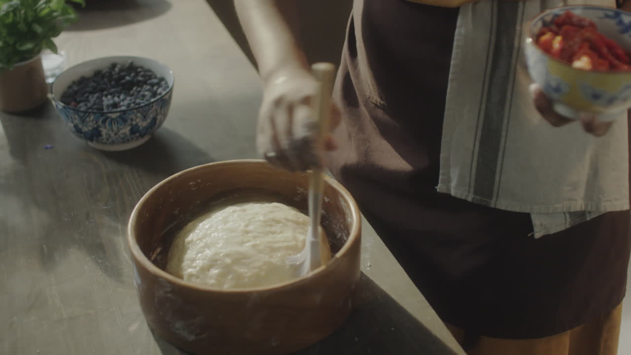 Food Blogger Adding Oil to Dough