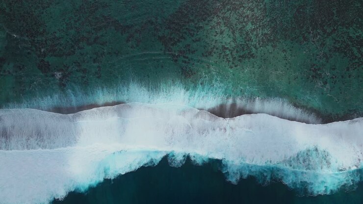 Abstract surf waves colorful sun aqua turquoise shallow coral reef Teahupoo Tahiti aerial drone birdseye view French Polynesia surf wave Pacific Ocean Channel Point Faremahora Pass Havae static
