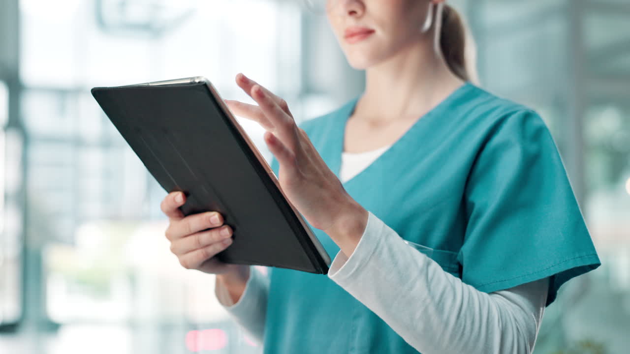 A healthcare professional using a tablet