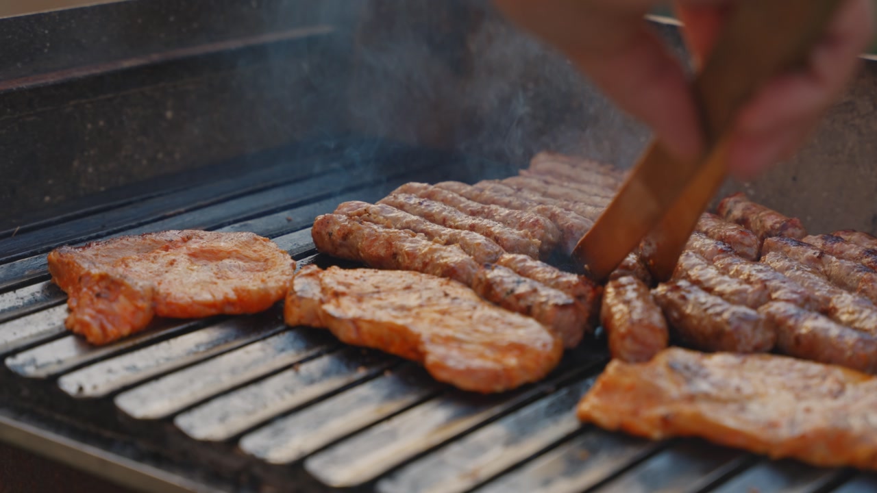 Grilling meat on barbecue during outdoor gathering, relaxed summer food lifestyle