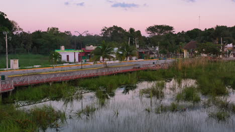 aerial landscape of empty road over laguna coba in rural town of quintana roo mexico at golden hour sunset