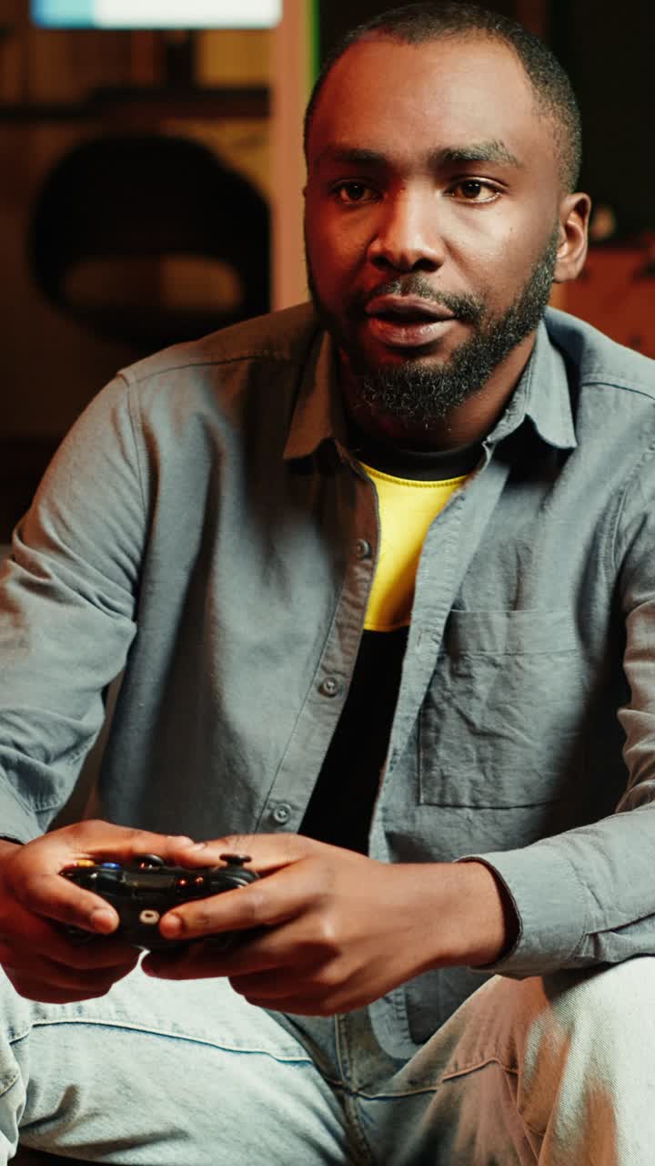 Vertical video Man arriving home, gaming and enjoying leisure time on couch
