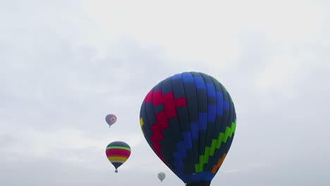 aerial view of hot air balloons in the sky.