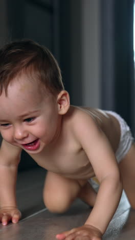 happy smiling adorable baby in diaper crawls by the room. black cat follows the child. vertical video