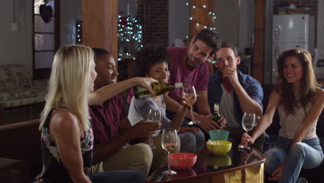 young adult friends drinking and eating snacks at home, shot on r3d