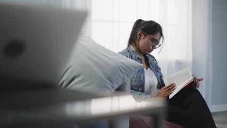 Focused-Indian-student-learns-new-information-in-textbook