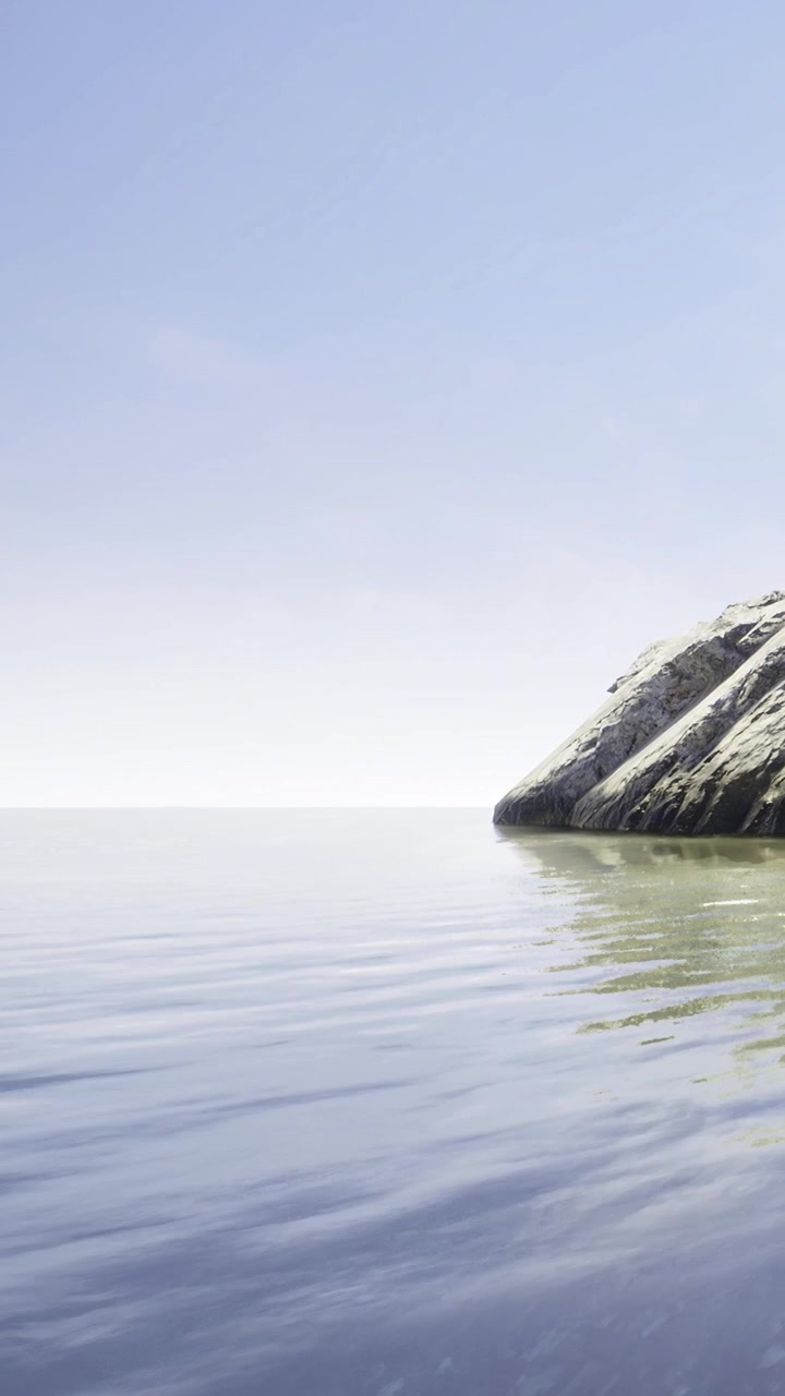 Calm water reflects rocks under clear sky during daytime