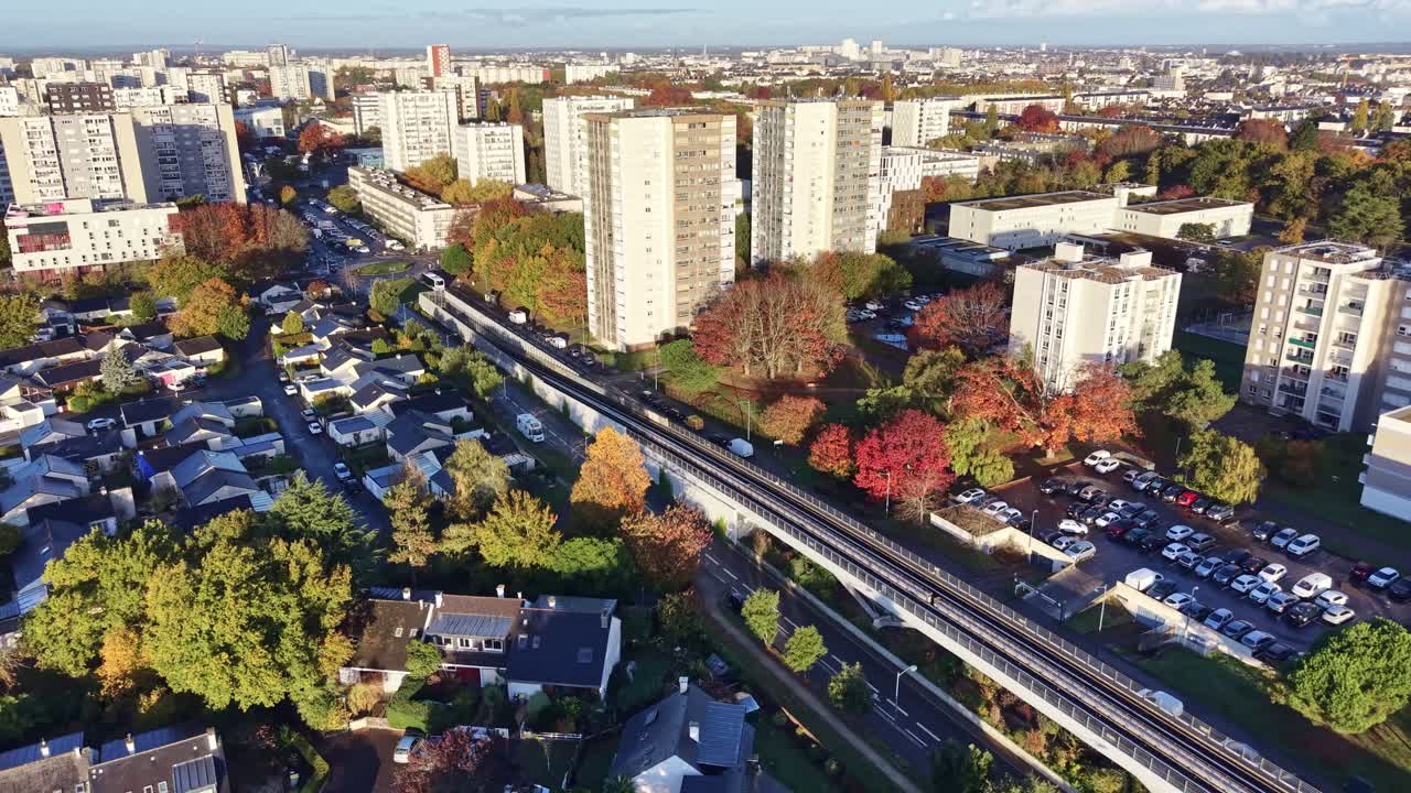 Aerial of La Poterie metro and streets network in Rennes, France, medium establishing pullback at sunset
