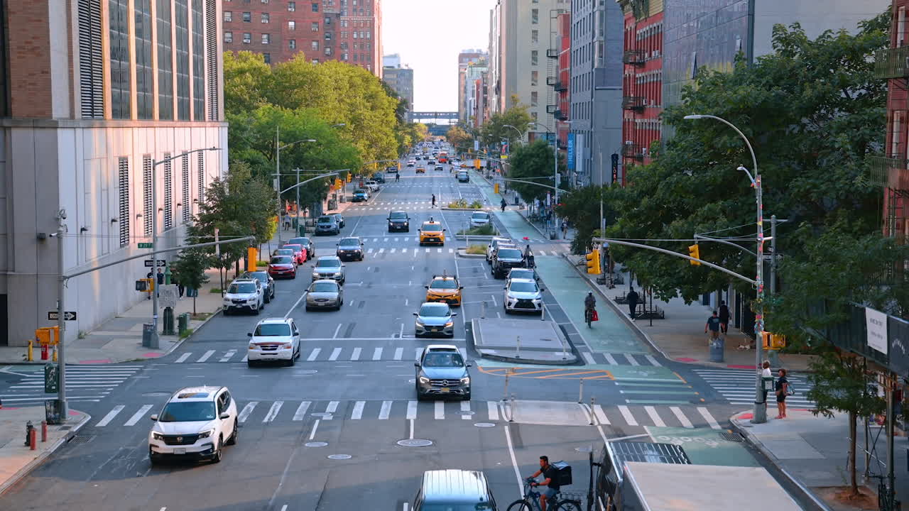 New York, USA, 4 August 2025: New York City avenue with traffic and residential blocks. A wide Manhattan avenue filled with cars, taxis, and lined with residential blocks under the afternoon light