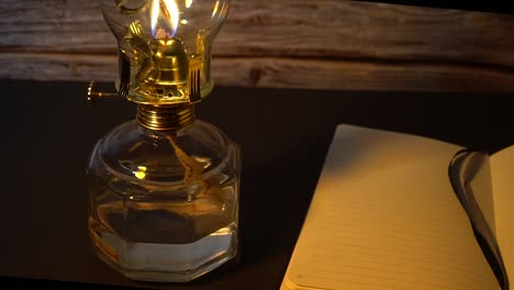 old hurricane oil lamp and an open book