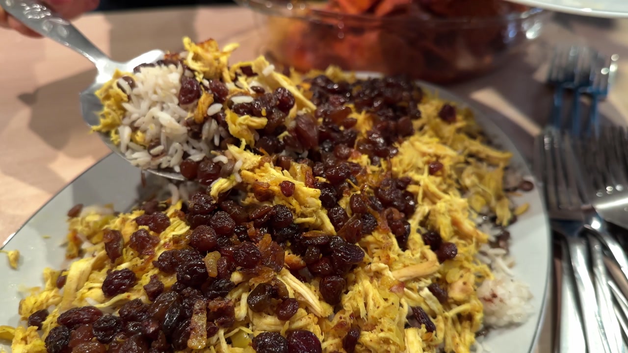 Adas polo rice Persian lentil rice with saffron raisins and fried topping shines at family gatherings Served with salad kashke bademjan and sandwich cake for a delicious party table thanksgiving food