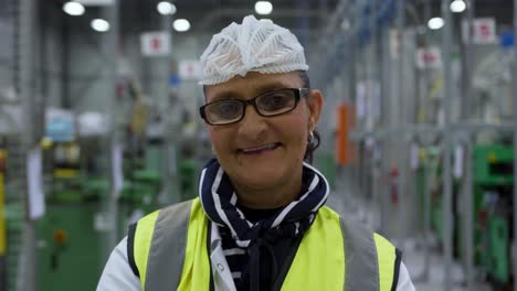 Warehouse-female-worker-looking-at-camera-with-arms-crossed