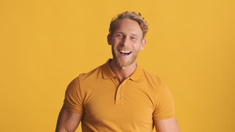 shocked and happy man in yellow polo t-shirt