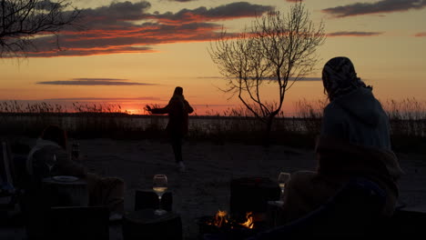 friends group having fun beach party in sea coastline sunset horizon landscape.