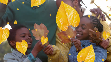 Animation-Von-Herbstblättern,-Die-über-Afroamerikanische-Eltern-Mit-Sohn-Und-Tochter-Im-Park-Fallen