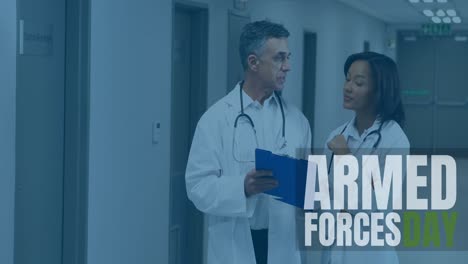 animation of armed forces day text over diverse doctors talking in hospital