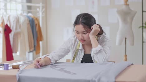 young female fashion designer bored, tried