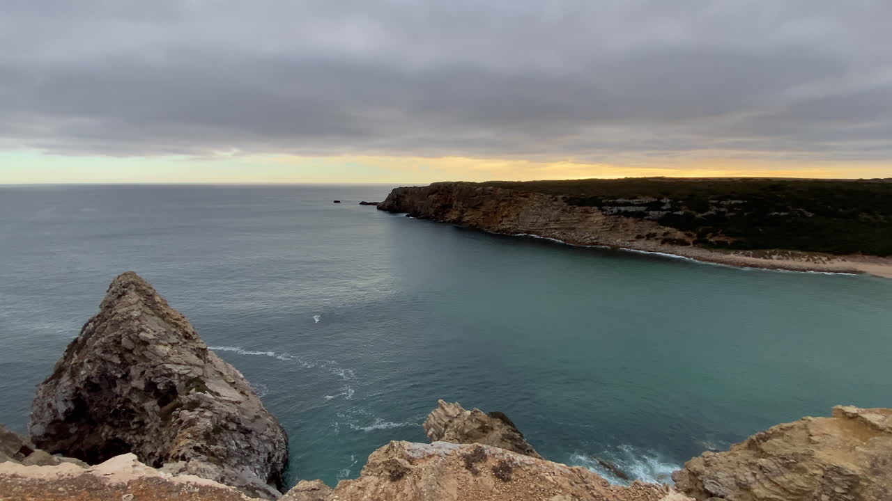 The sun fades into the mist, turning the waves into silver and the horizon into calm fire