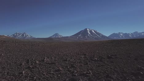 Drone-shot-revealing-beautiful-high-altitude-volcanic-Lake-Miscanti,-Volcanic-mountains-in-Antofagasta-region-in-northern-Chile,-Bolivia